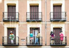 Building with dresed manequins on balconies on a street of Madri