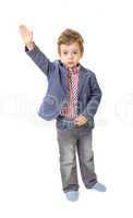 Little boy with his hand lifted up on white