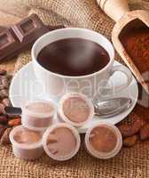 Cup of hot chocolate with pods.