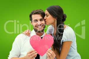 Composite image of pretty brunette giving boyfriend a kiss and h