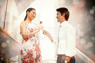 Man offering a red rose to girlfriend