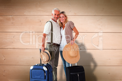 Composite image of happy couple ready to go on holiday