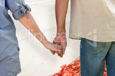 Composite image of couple holding hands in park