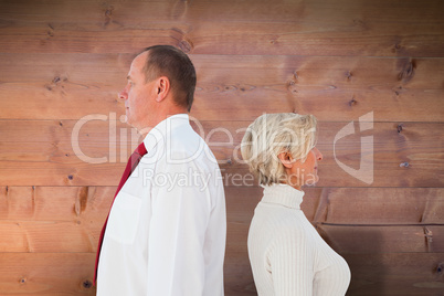 Composite image of older couple standing not facing each other