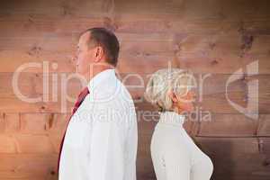 Composite image of older couple standing not facing each other