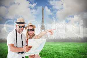 Composite image of happy tourist couple using map and pointing