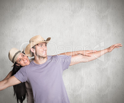 Composite image of man giving his pretty girlfriend a piggy back