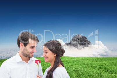 Composite image of handsome man offering his girlfriend a rose