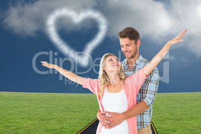 Composite image of attractive young couple smiling and embracing