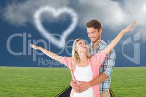 Composite image of attractive young couple smiling and embracing