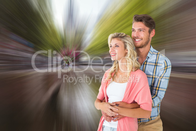 Composite image of attractive young couple embracing and smiling