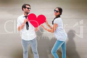 Composite image of hipster couple smiling at camera holding a he