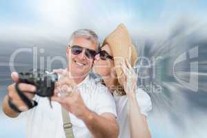 Composite image of vacationing couple taking photo