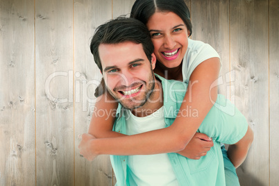 Composite image of happy casual man giving pretty girlfriend pig