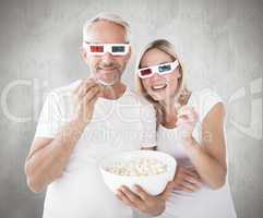 Composite image of happy couple wearing 3d glasses eating popcor