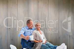 Composite image of happy mature couple having coffee