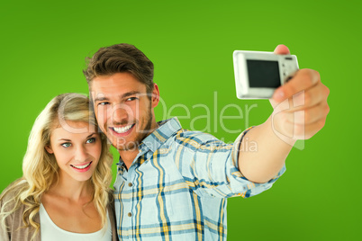 Composite image of attractive couple taking a selfie together