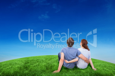 Composite image of couple sitting on floor together