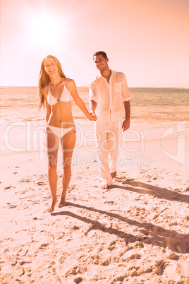 Smiling blonde walking away from man holding her hand