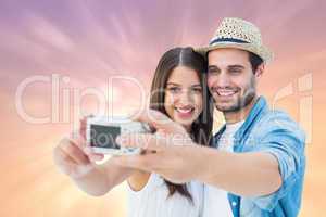 Composite image of happy hipster couple taking a selfie