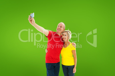 Composite image of happy mature couple taking a selfie together