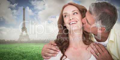 Composite image of man giving his partner a kiss