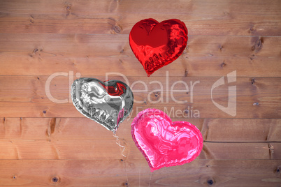 Composite image of love heart balloons