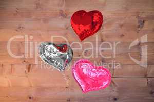 Composite image of love heart balloons