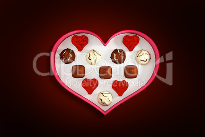 Composite image of heart shaped box of candy