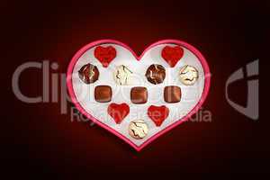 Composite image of heart shaped box of candy