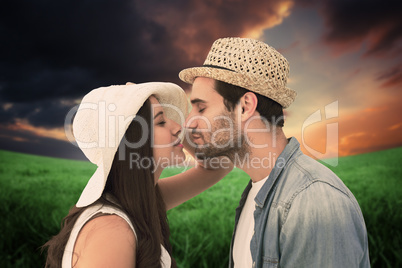 Composite image of happy hipster couple about to kiss