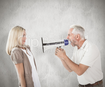 Composite image of angry man shouting at girlfriend through mega