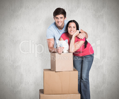 Composite image of young couple with moving boxes