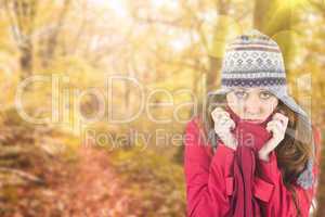 Composite image of cold redhead wearing coat and hat