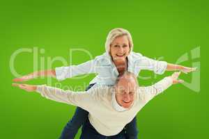 Composite image of happy mature couple having fun