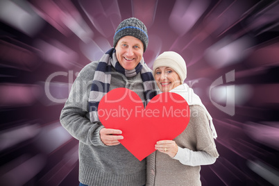 Composite image of happy mature couple in winter clothes holding