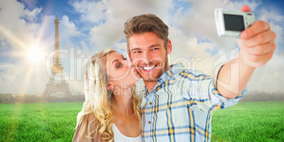 Composite image of attractive couple taking a selfie together Composite image of attractive couple taking a selfie together