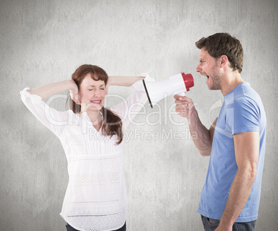 Composite image of man shouting through a megaphone