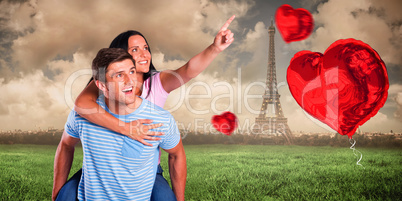 Composite image of young man giving girlfriend a piggyback ride