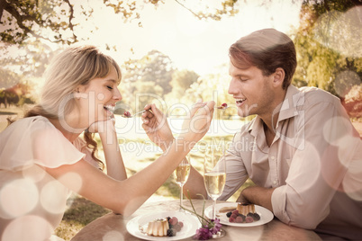 Cute couple feeding each other dessert