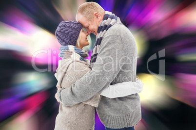 Composite image of happy mature couple in winter clothes hugging