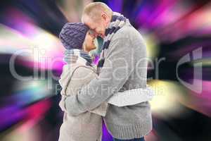 Composite image of happy mature couple in winter clothes hugging