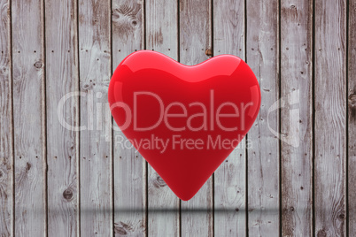 A large red heart shaped balloon