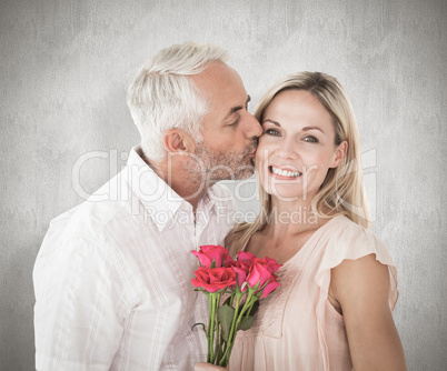 Composite image of affectionate man kissing his wife on the chee