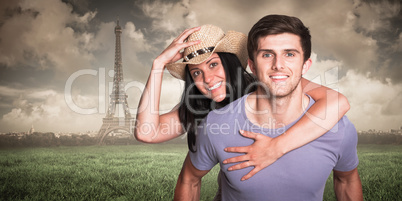 Composite image of man giving his pretty girlfriend a piggy back