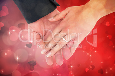 Composite image of close-up of bride and groom with hands togeth