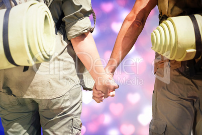 Composite image of hitch hiking couple standing holding hands on