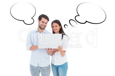 Composite image of attractive young couple holding their laptop