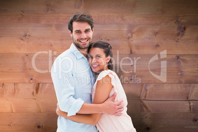 Composite image of attractive young couple hugging and smiling a