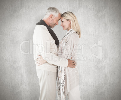 Composite image of happy couple standing and hugging